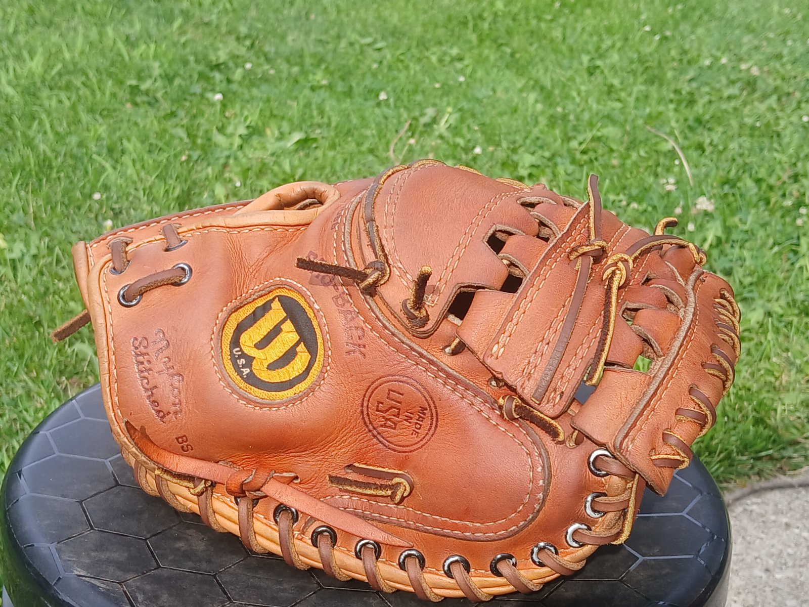 A baseball catcher's mitt fully restored and relaced with the Extra Innings Renewal package